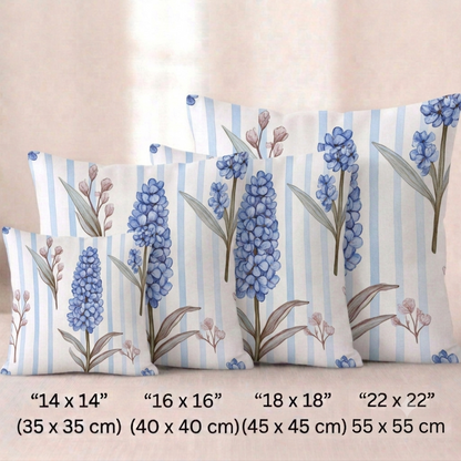 Vier quadratische  Baumwoll - Kissenbezüge mit botanischem Muster vor einem hellen Hintergrund. Das Design zeigt vertikale, blaue Traubenhyazinthen mit grünlich-braunen Blättern und zarte, bräunliche Knospenzweige. Der Hintergrund besteht aus feinen, vertikal verlaufenden hellblau