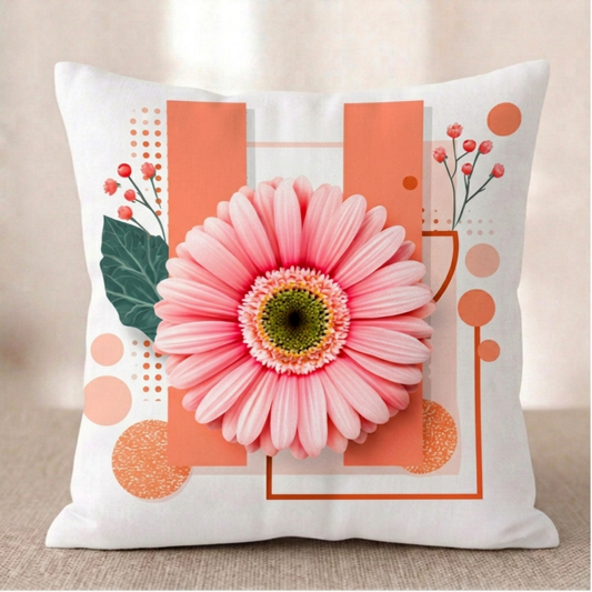 Ein quadratischer Baumwoll - Kissenbezug in Weiß vor einem hellen Hintergrund. Das Design zeigt im Zentrum eine große rosa Gerbera-Blüte mit einer grün-gelben Mitte. Die Blüte liegt auf zwei breiten, vertikalen Balken in softem Orange. Im Hintergrund befinden sich feine, braune geometrische Rahmen, orangefarbene Punkte und ein dezenter Zweig mit kleinen rosa Knospen.