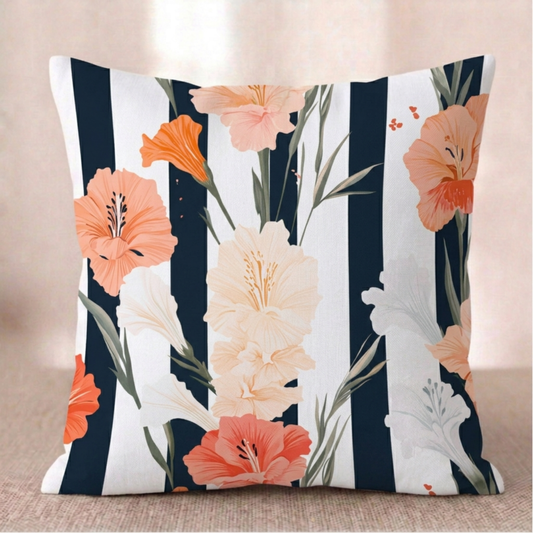 Ein quadratischer Baumwoll Kissen-bezug mit modernem, floralem Muster vor einem hellen Hintergrund. Das Design zeigt große, elegante Blüten in Pfirsich, leuchtendem Orange und Cremeweiß sowie schmale grüne Blätter. Der Hintergrund besteht aus kontrastreichen, vertikalen Streifen in Schwarz und Weiß.