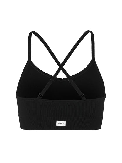 Eng anliegender Sport-BH  in der Farbe schwarz aus geripptem Material mit schmalen Trägern, V-förmigem Ausschnitt und breitem, elastischem Unterbrustband.