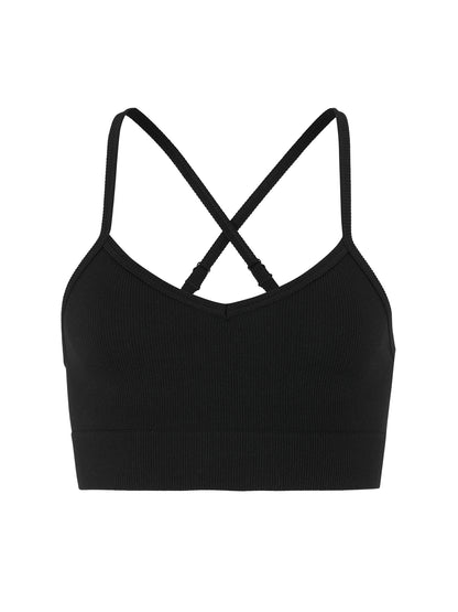 Eng anliegender Sport-BH  in der Farbe schwarz aus geripptem Material mit schmalen Trägern, V-förmigem Ausschnitt und breitem, elastischem Unterbrustband.