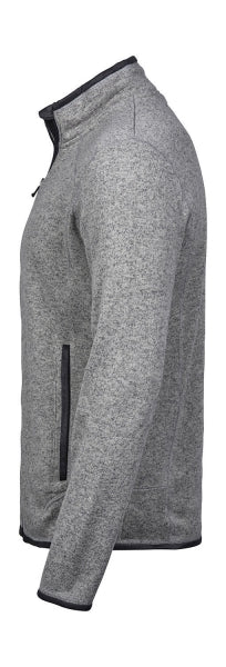 Graue Outdoor Fleece Jacke in geradem, körpernahem Schnitt. Die hüftlange Fleecejacke hat einen hohen Stehkragen, lange Ärmel und zwei seitliche Reißverschlusstaschen. Das schlichte Design wird durch dezente schwarze Details an Reißverschlüssen und Abschlüssen ergänzt.